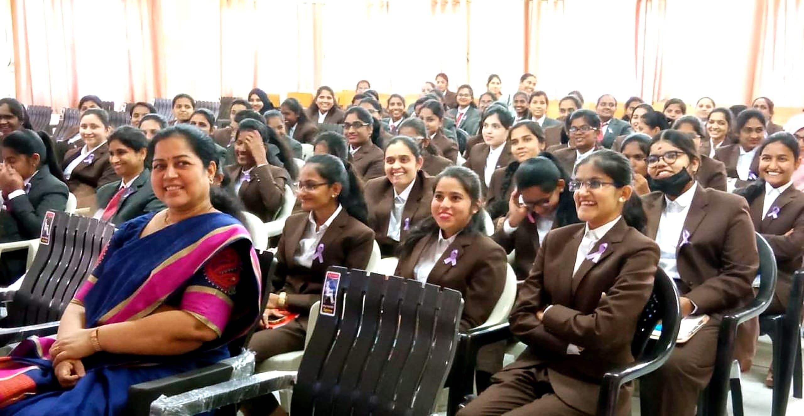 Smiling students wearing cancer-awareness ribbons at a Subha Trust awareness session